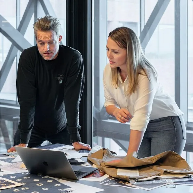 Homem e mulher olhando para a tela de um laptop