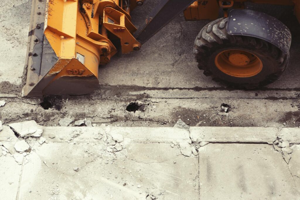 Close-up of an excavator working on road construction, showcasing the industrial process.