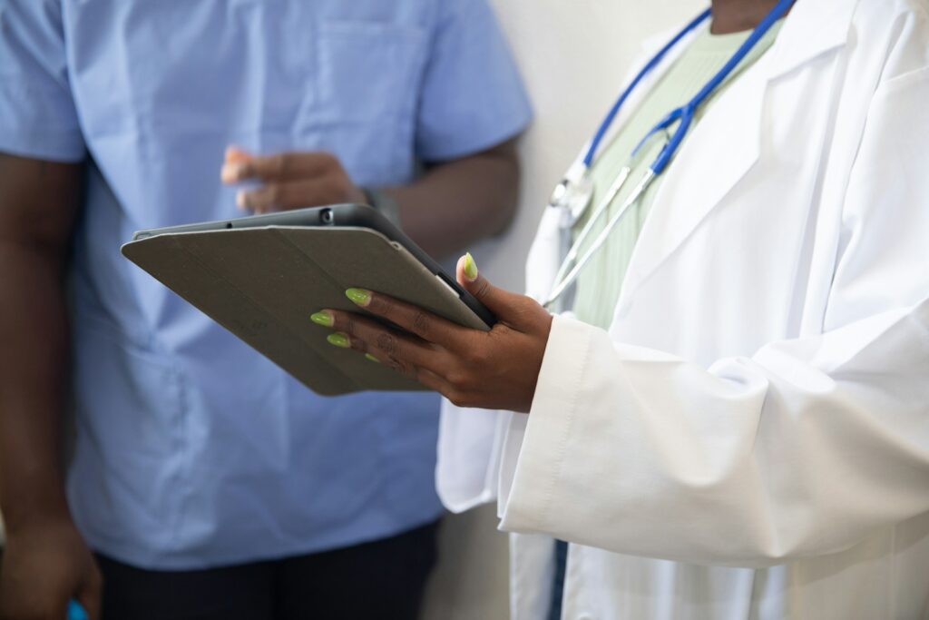 a doctor showing a patient something on the tablet