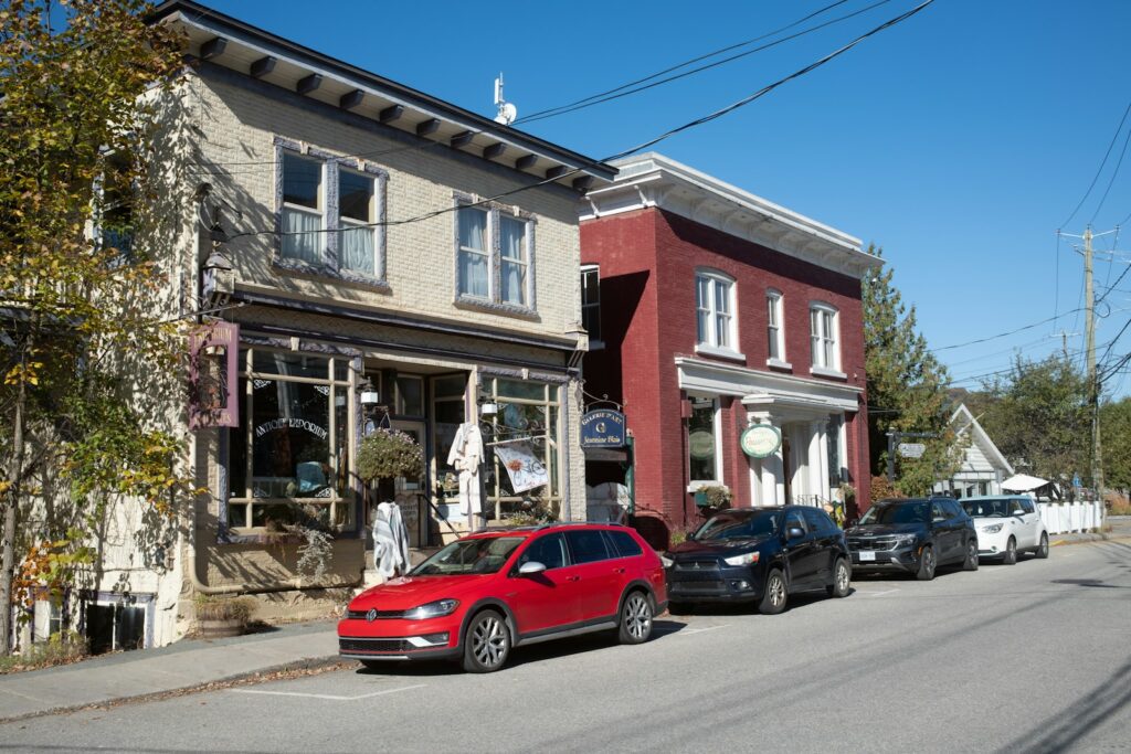 A red car parked in front of a building